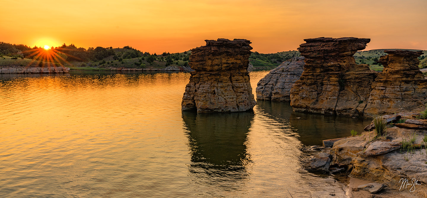 Sunset over Wilson Lake with rock formations rising from the water